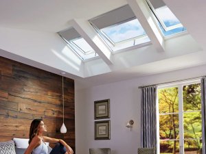 woman looking up to skylights in the bedroom in sydney